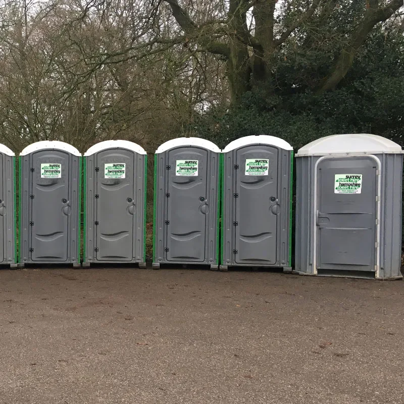 A row of our portable toilets lined up on the yard, cleaned and ready to go out